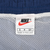 Nike label detail inside navy swim trunks with white mesh lining