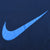 Close-up of large light blue Nike Swoosh print on navy fabric
