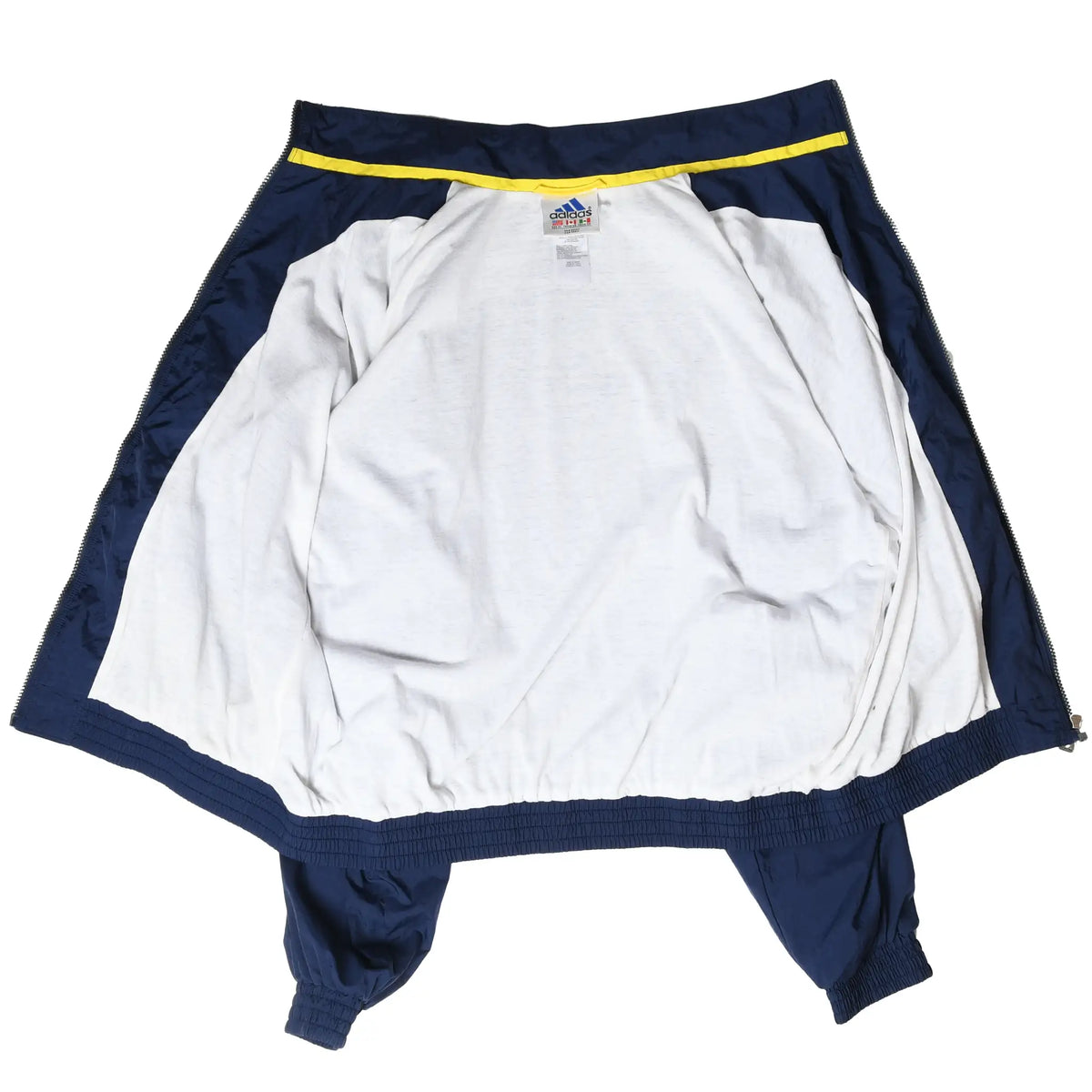 Inside of unzipped Adidas windbreaker showing white lining and navy trim