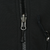 Close-up of black front zipper and adjacent chest pocket zipper