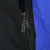 Close-up of black front zipper and metal pull beside the windbreaker's blue panel