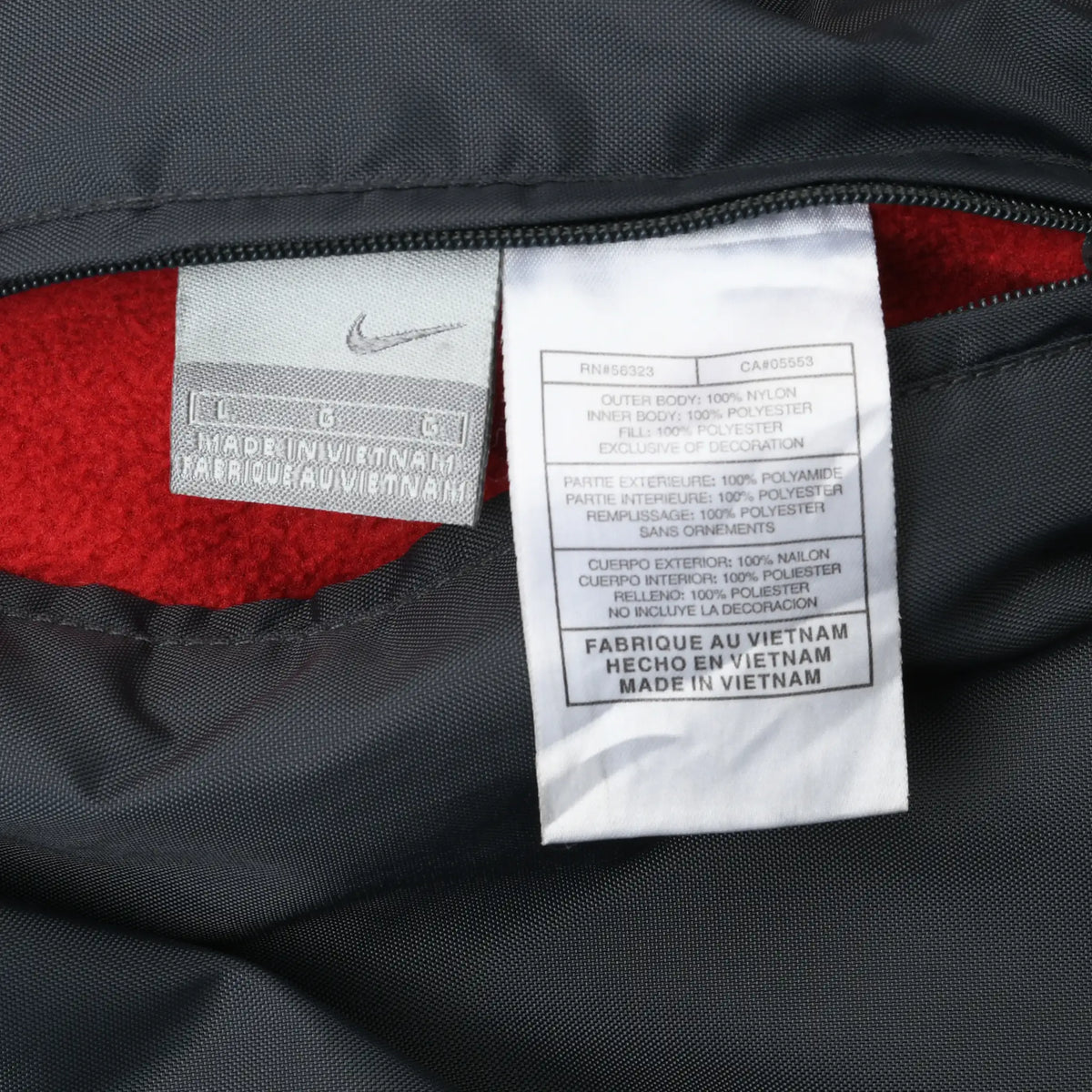 Close-up of Nike Swoosh label and care tag inside the reversible jacket