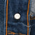 Close-up of Levi's jeans button back stamped 524 beside orange stitching