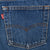 Levi's blue jeans back pocket with orange arcuate stitching and red tab