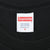 Supreme neck label showing pre-shrunk 100% cotton, Made in U.S.A., and size S