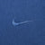 Close-up of tonal blue Nike Swoosh embroidery on T-shirt chest