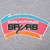Close-up of San Antonio Spurs chest print in black, teal, pink, and orange