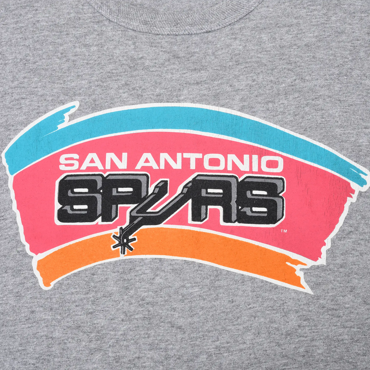 Close-up of San Antonio Spurs chest print in black, teal, pink, and orange