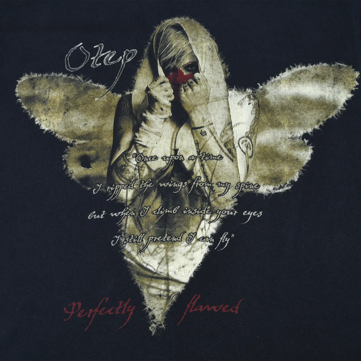Close-up of Otep Perfectly Flawed print with bandaged winged figure and script text