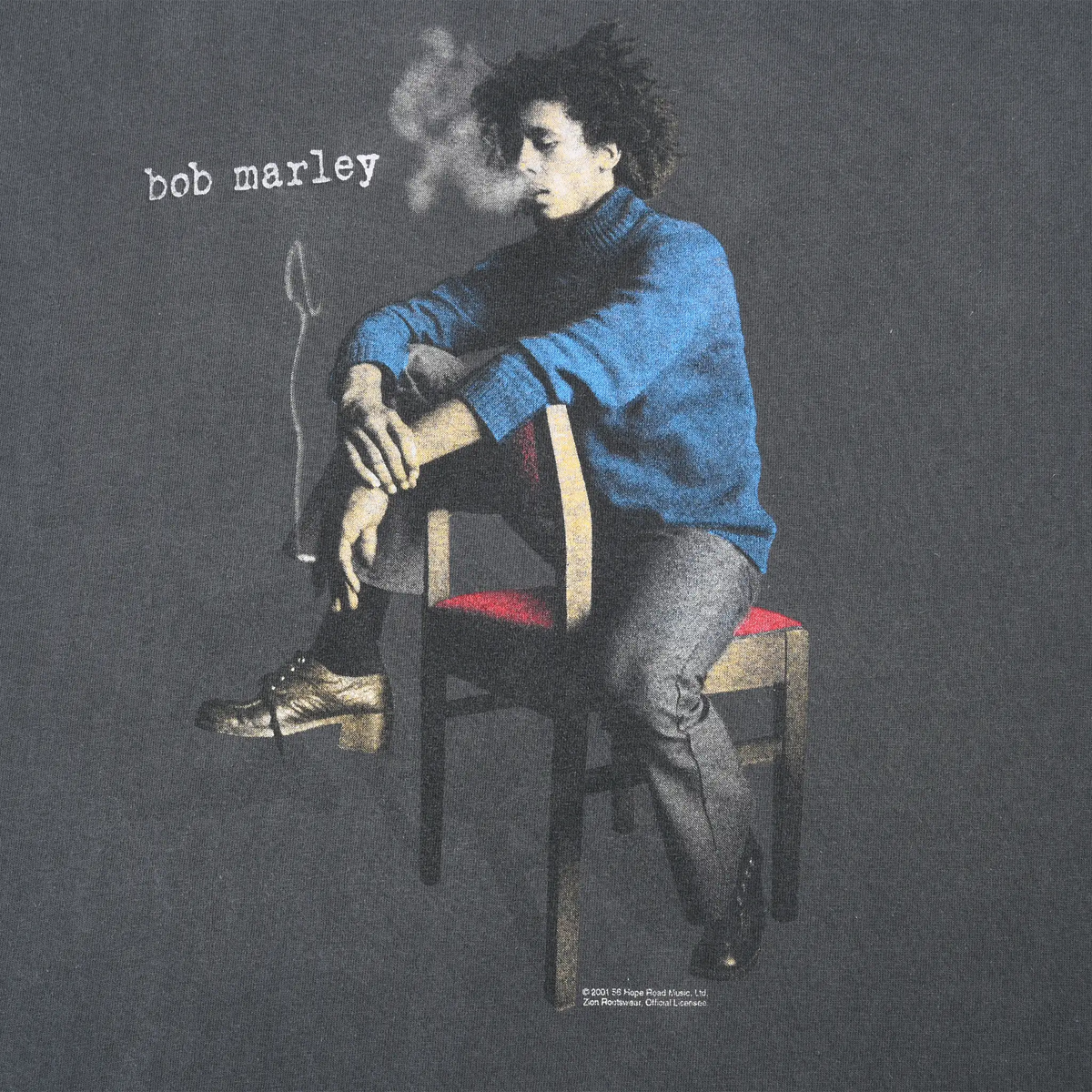 Close-up of front Bob Marley seated portrait print with white name text