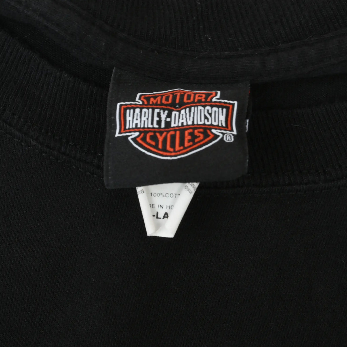 Close-up of Harley-Davidson Motor Cycles neck tag on black T-shirt