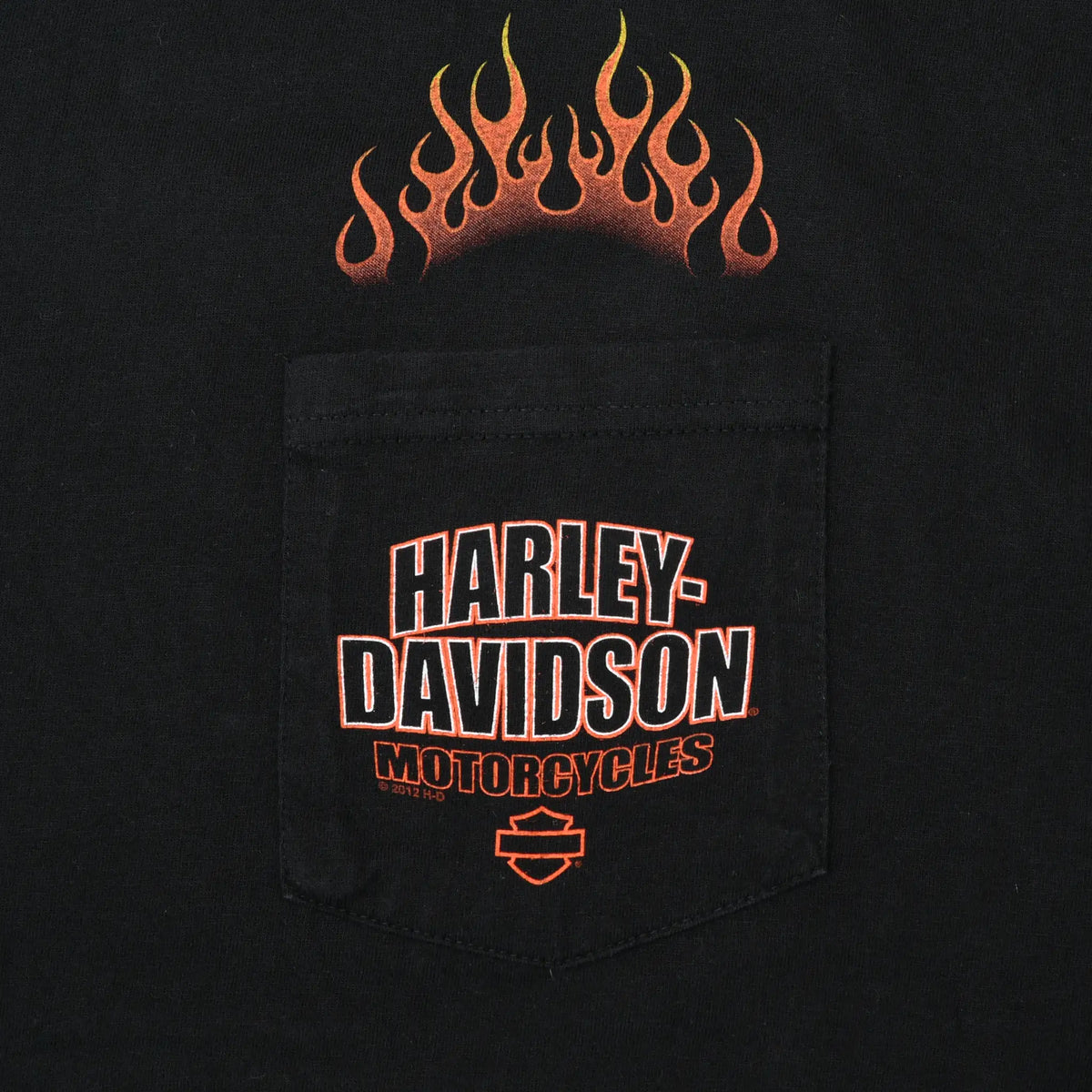 Close-up of black chest pocket with Harley-Davidson Motorcycles print and orange flames