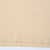 Close-up of tan T-shirt fabric and bottom hem stitching
