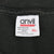 Close-up of Anvil XL neck tag stating pre-shrunk 100% cotton and made in USA