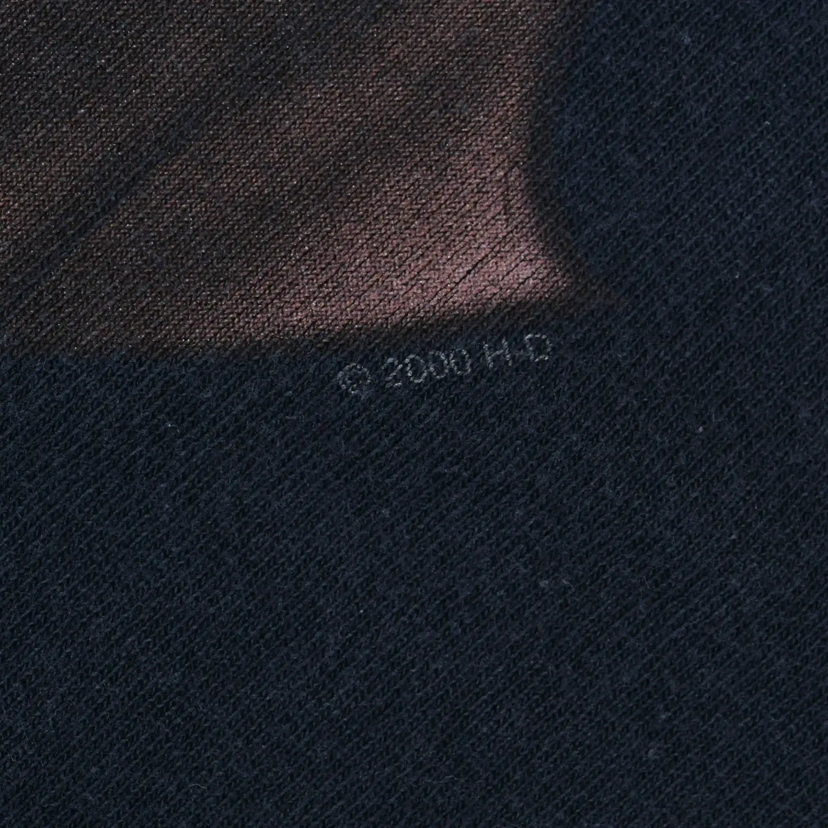 Close-up of faint copyright marking printed on black fabric