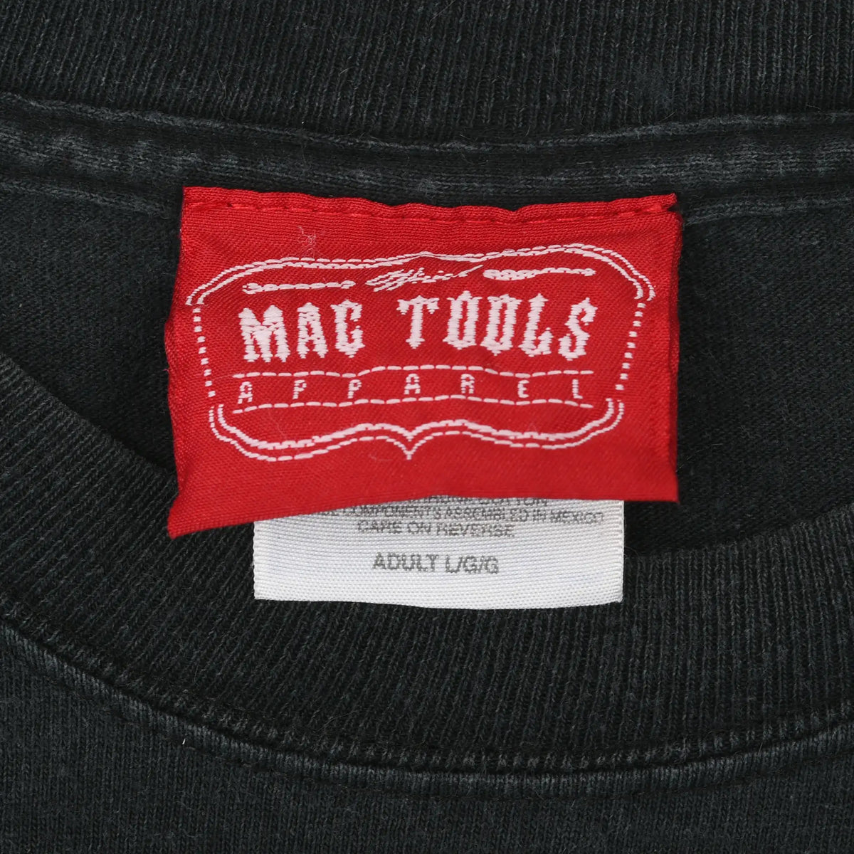 Red Mac Tools Apparel neck label with Adult Large size tag on black T-shirt