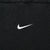 Close-up of small white Nike Swoosh embroidery centered on black chest fabric