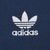 Close-up of white adidas Trefoil logo embroidery on navy blue fabric