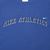 Close-up of arched Nike Athletics chest lettering and white Swoosh on blue sweatshirt
