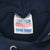 Close-up of TRI-TECH neck label inside the navy sweatshirt