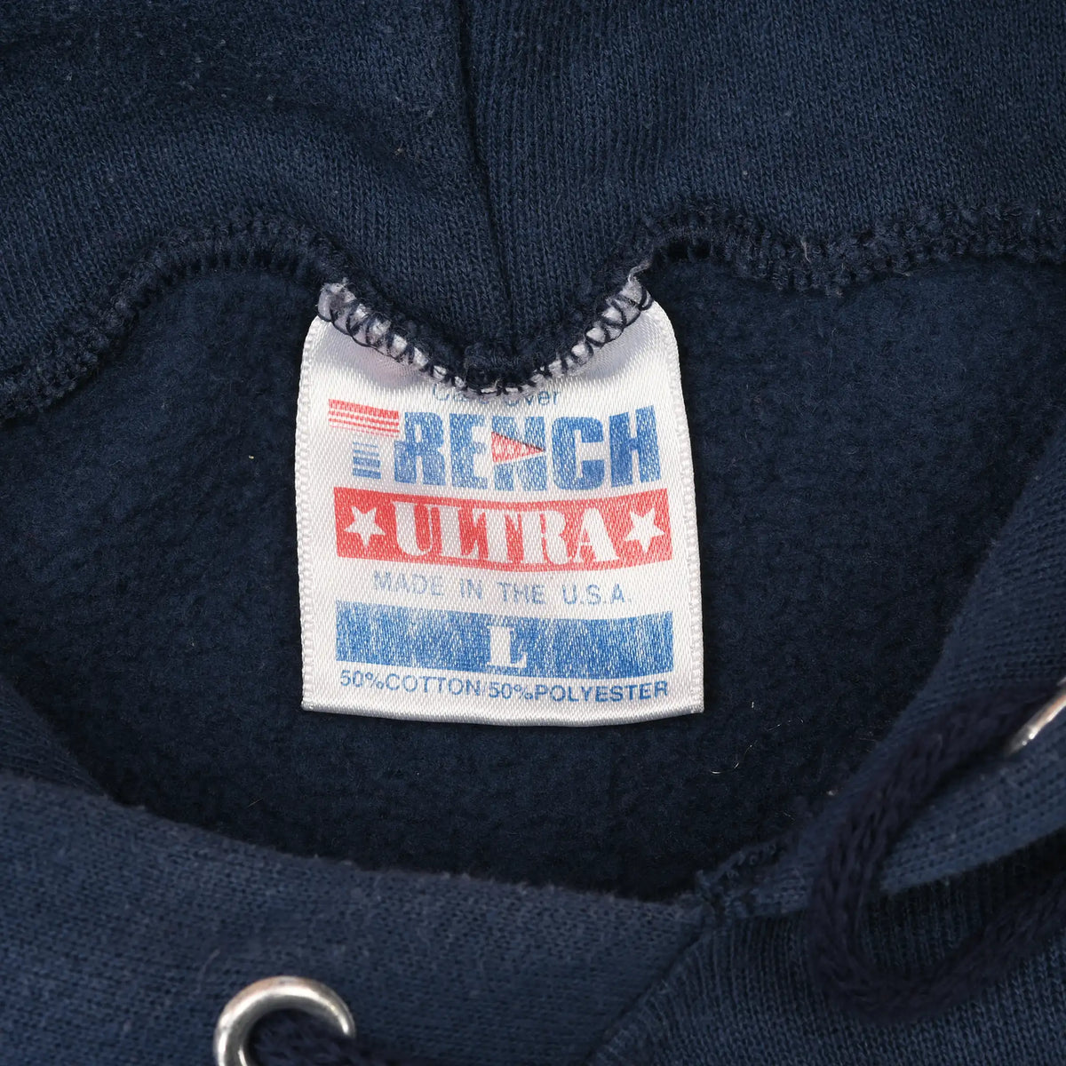 Close-up of TRI-TECH neck label inside the navy sweatshirt