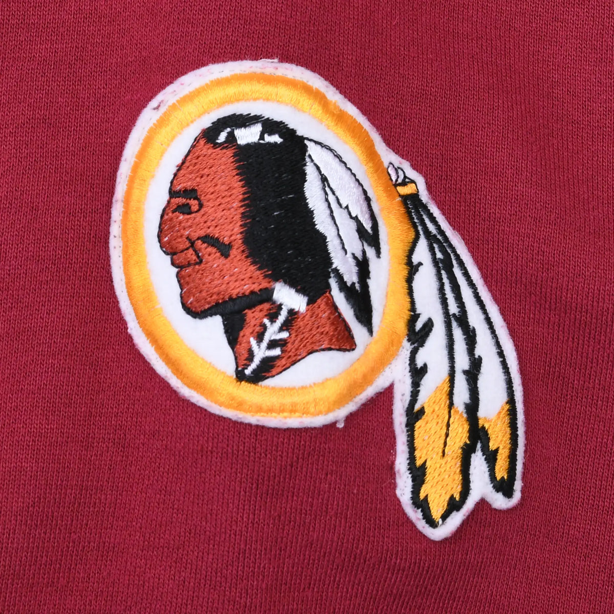 Close-up of embroidered Washington Redskins team logo patch on the burgundy sleeve