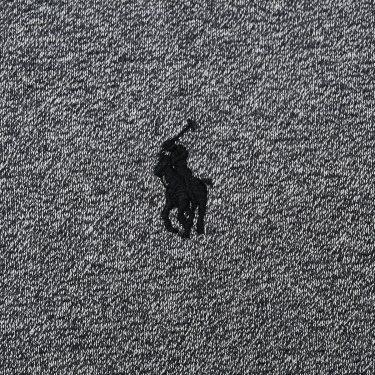 Close-up of black Polo pony embroidery on grey Ralph Lauren hoodie