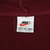 Close-up of Nike neck label marked XL on burgundy hoodie