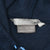Close-up of the Nike neck and care tags inside the navy fleece hoodie