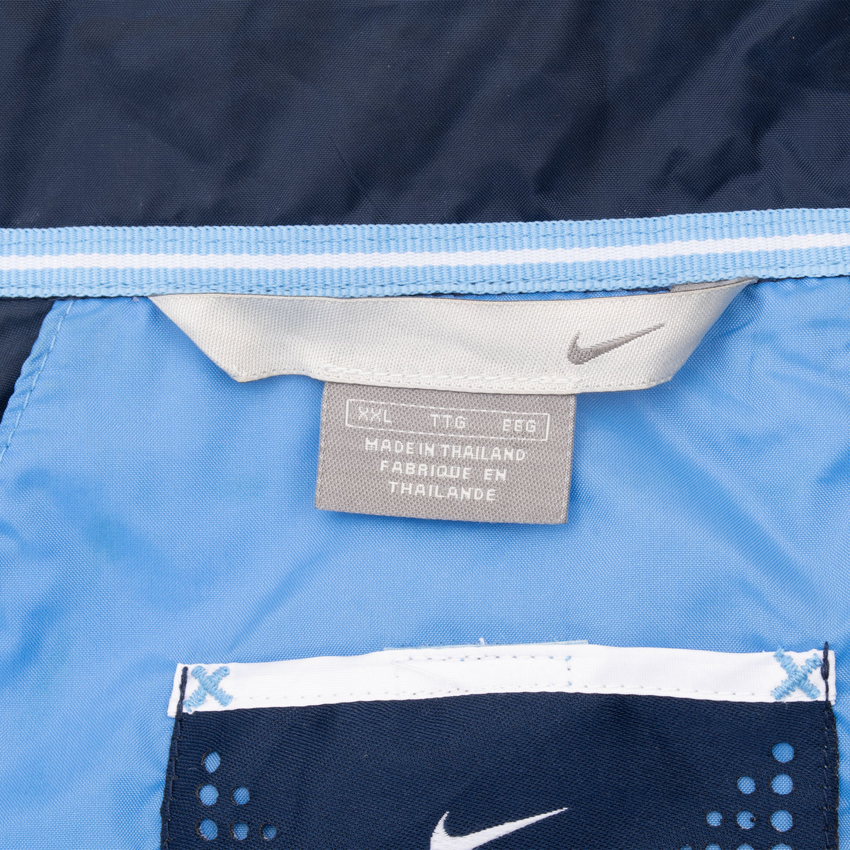 Nike windbreaker interior neck labels showing XXL sizing