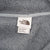 The North Face neck label and men's size large tag inside grey jacket