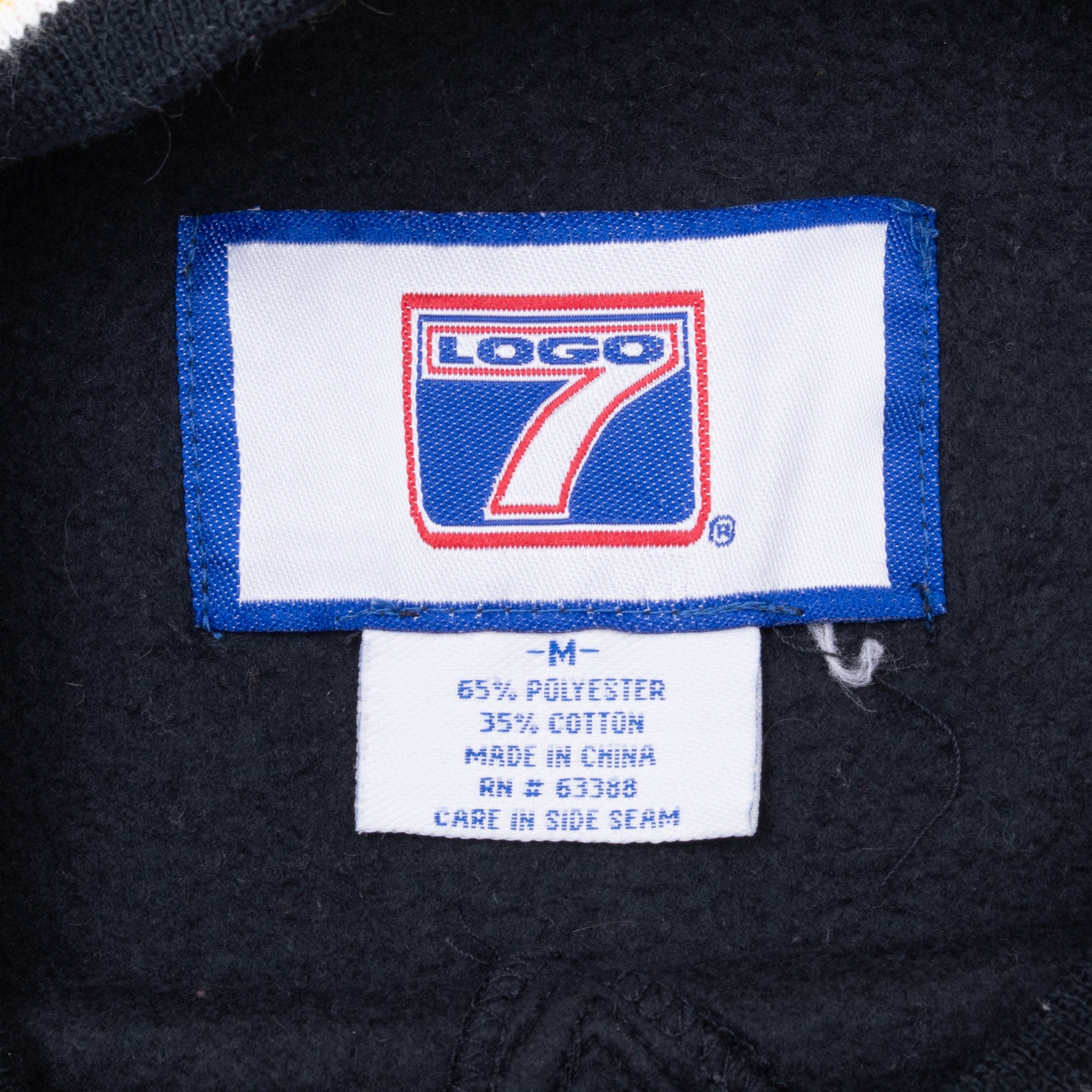 Logo 7 neck label and medium-size care tag inside Pittsburgh Steelers sweatshirt