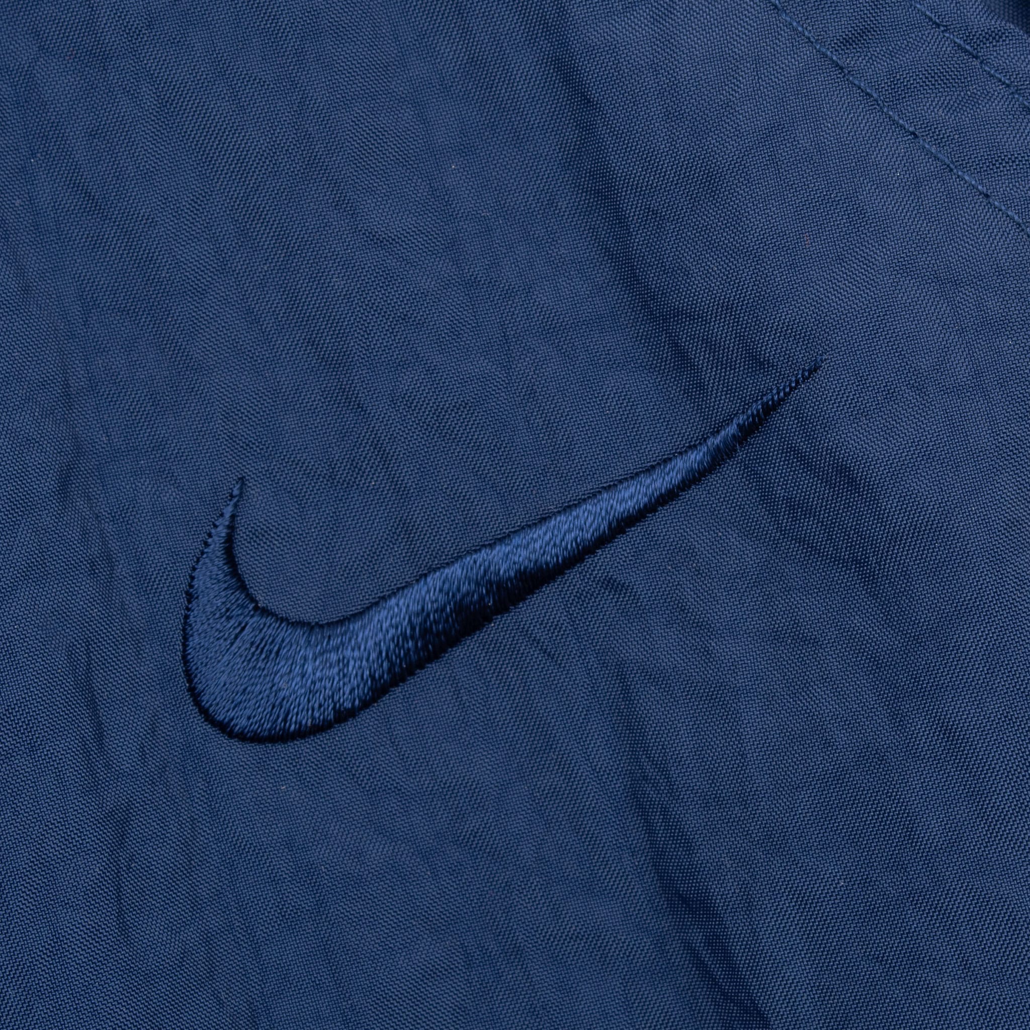 VINTAGE NIKE CLASSIC SWOOSH BLUE NYLON TRACK PANTS 1990S LARGE DEADSTOCK