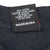 Close-up of care label with washing instructions and Made in USA text
