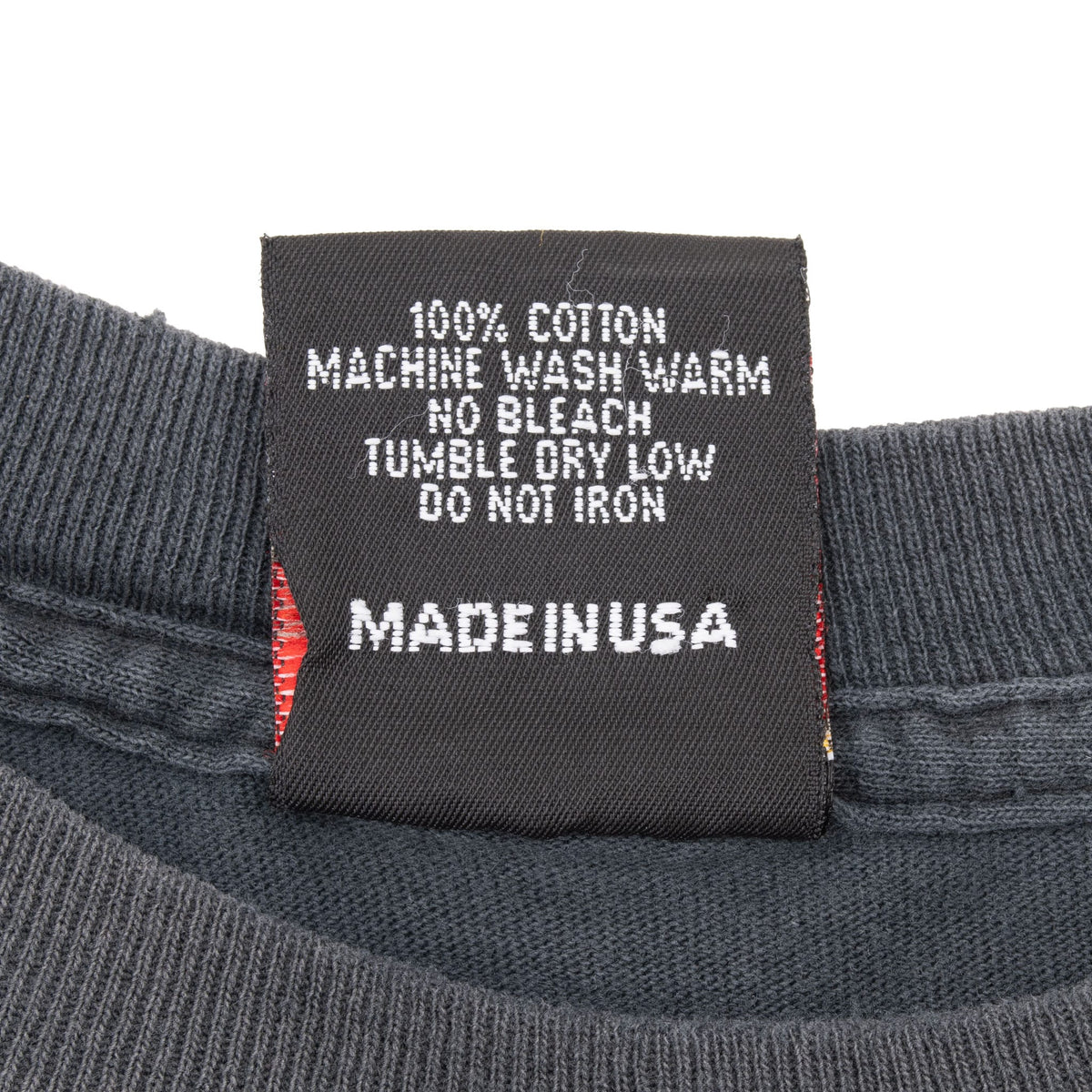 Close-up of care label stating 100% cotton and Made in USA