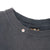 Close-up of black ribbed crew neck collar and interior seam