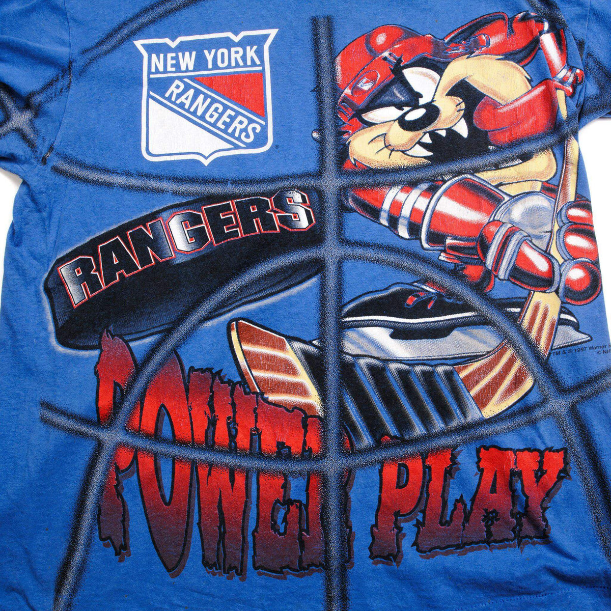 Close-up of Taz in Rangers hockey gear behind a goalie net with NHL team shield