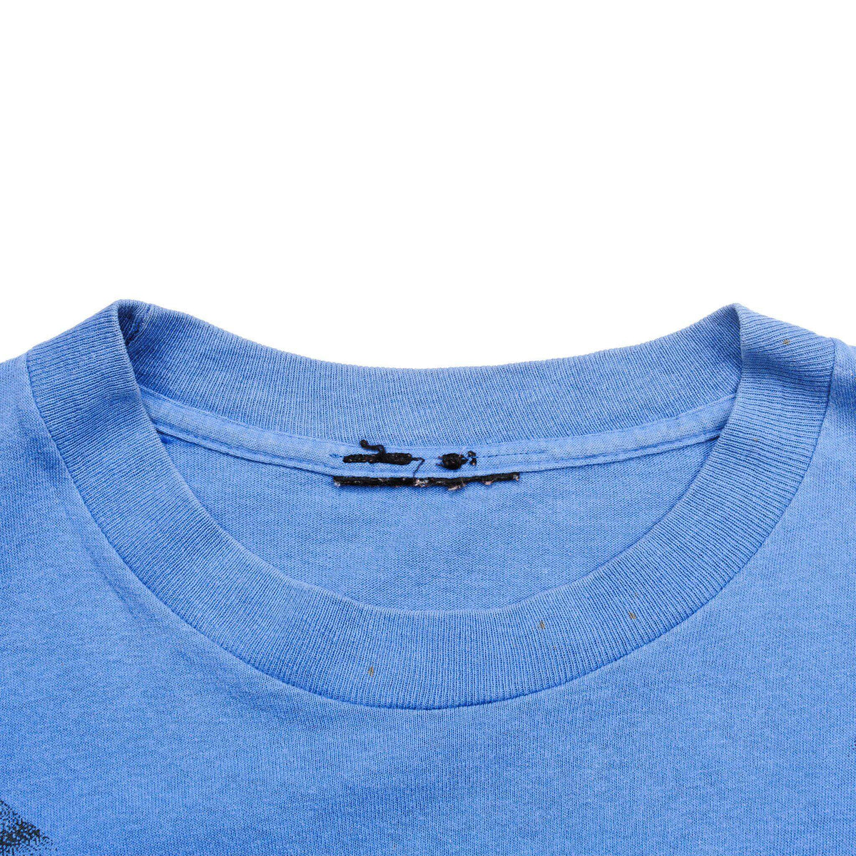 Close-up of blue ribbed crew neck and faded interior collar print