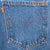 Close-up of a rear pocket with Levi's arcuate stitching and orange tab
