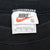 Nike neck tag marked XL and Made in U.S.A. inside black sleeveless T-shirt