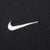 Close-up of white embroidered Nike Swoosh on black fabric