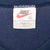 Nike neck tag marked XL and Made in USA inside navy sleeveless shirt