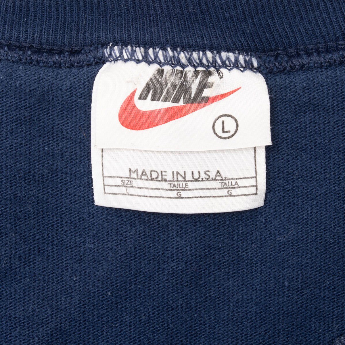 Nike neck tag showing size large and Made in USA text