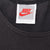 Close-up of white Nike neck label with red Swoosh and Made in U.S.A. text