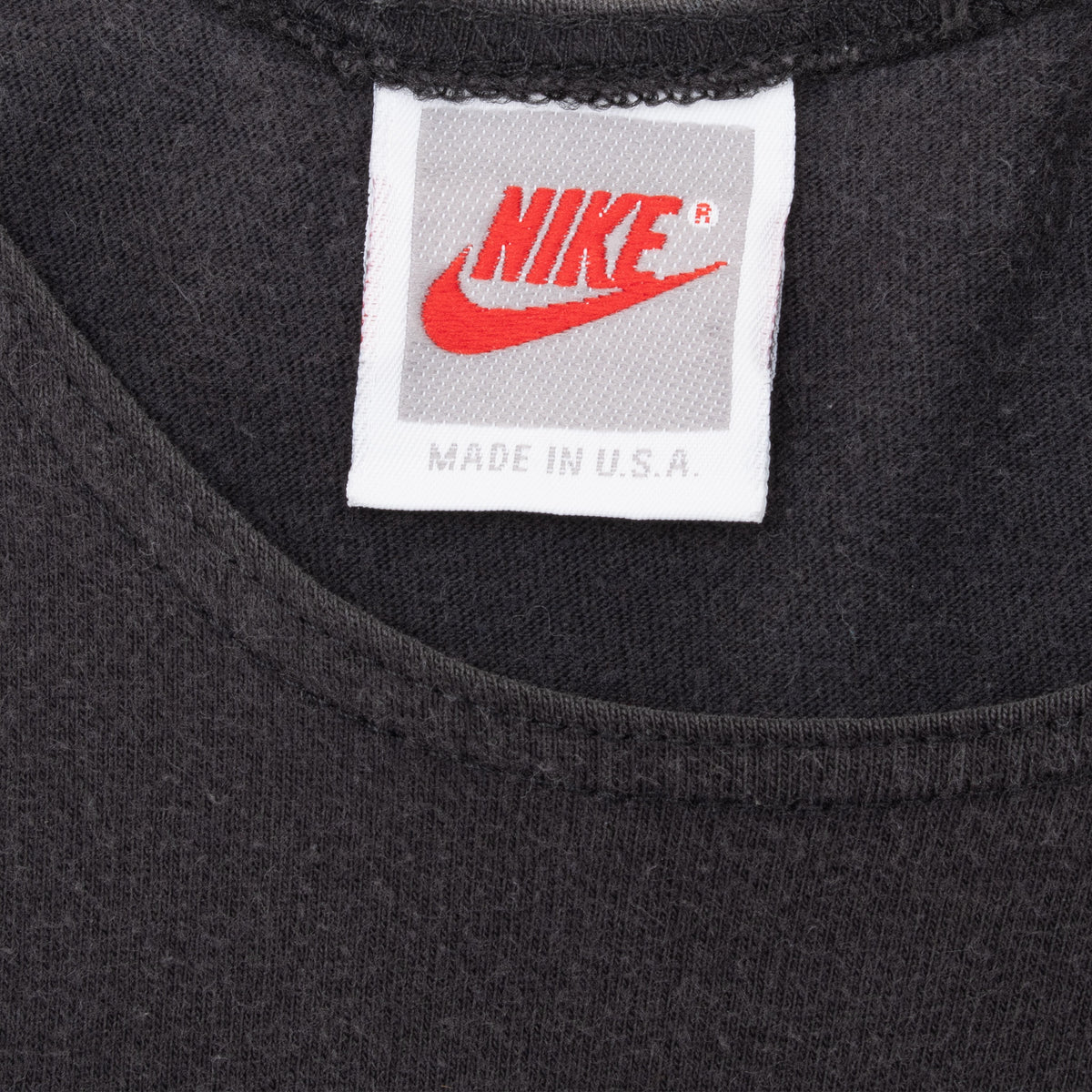 Close-up of white Nike neck label with red Swoosh and Made in U.S.A. text