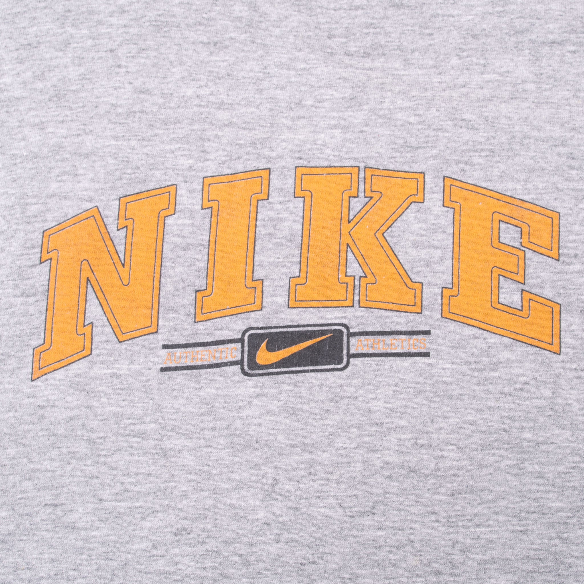 Close-up of orange Nike spellout, Swoosh, and Authentic Athletics chest print