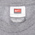 Close-up of Nike Team size large neck tag on grey T-shirt