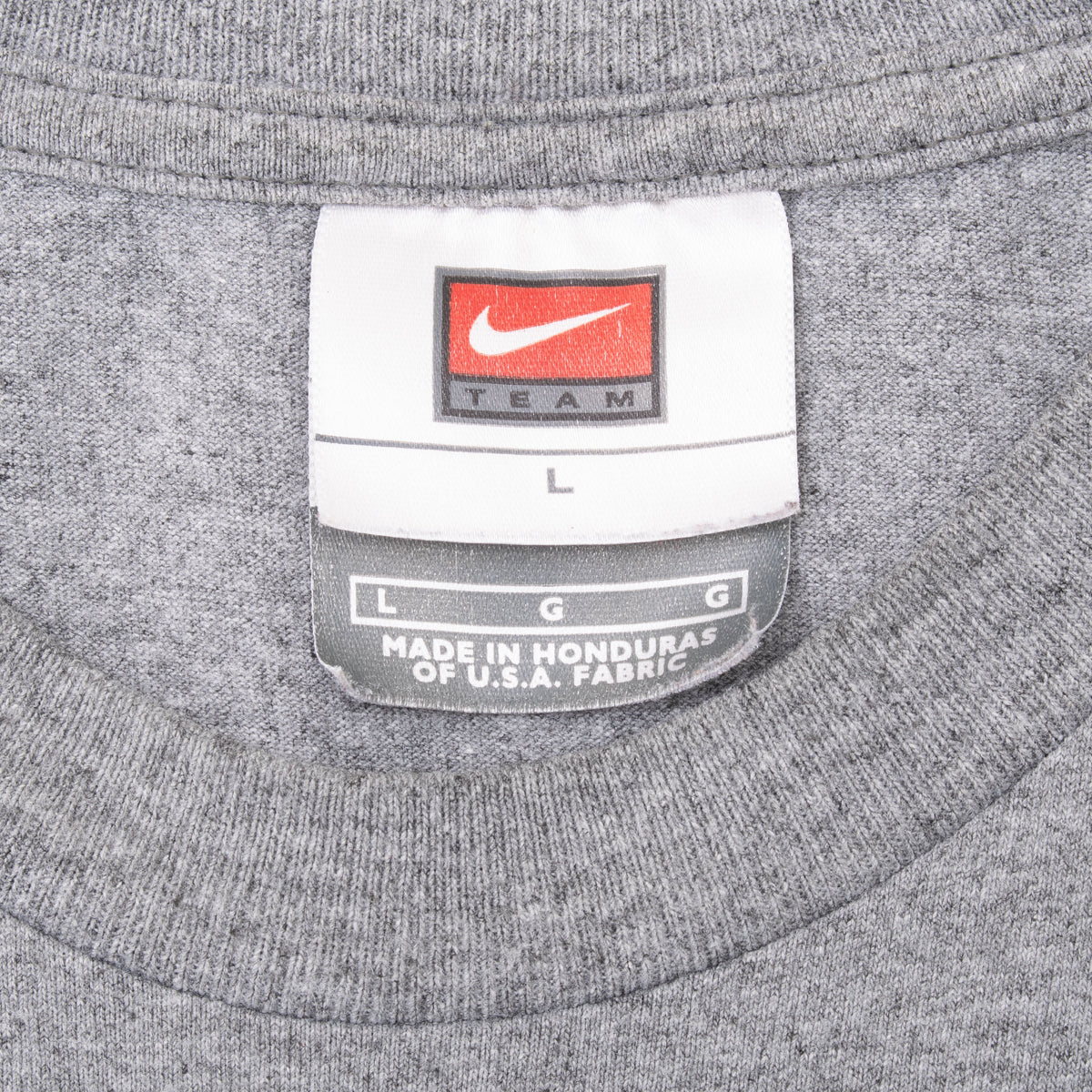 Close-up of Nike Team size large neck tag on grey T-shirt
