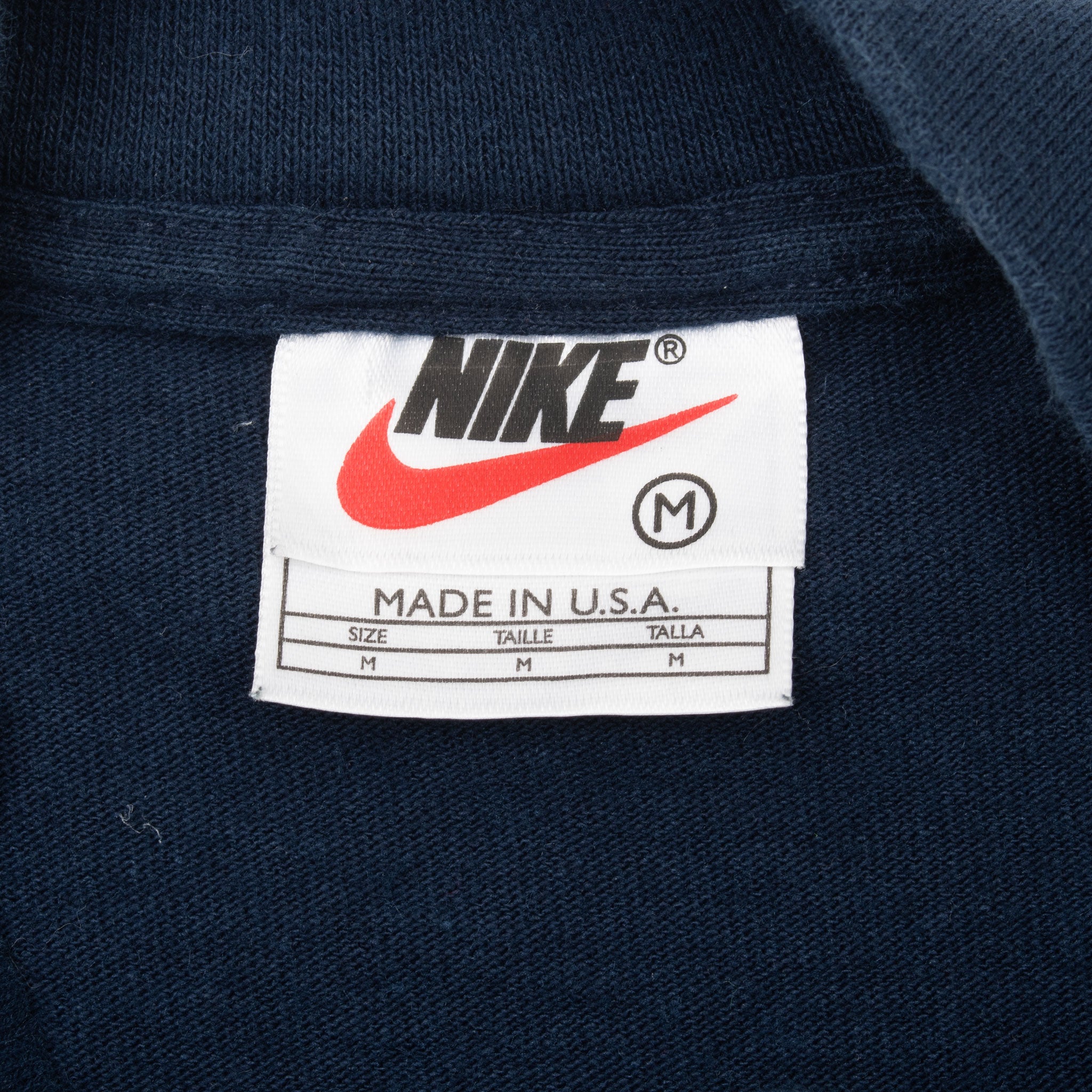 Nike neck tag showing medium size and Made in U.S.A.