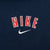 Close-up of red and white Nike wordmark embroidery with white Swoosh